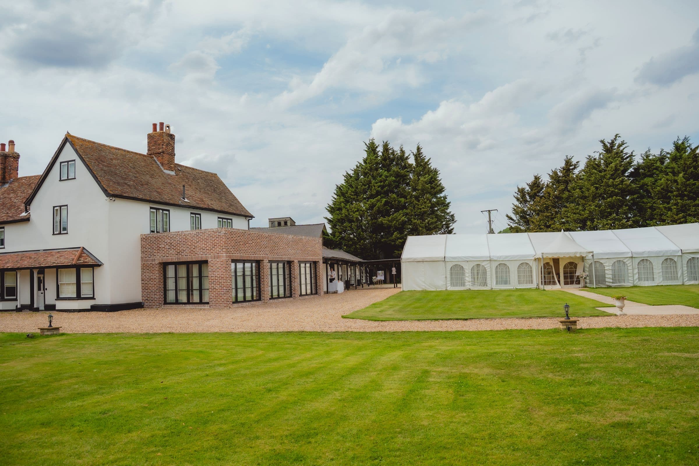 Minstrel Court's farmhouse and Garden Marquee in summer sunshine